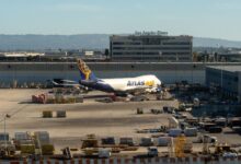 An Atlas Air jumbo jet is parked at an LAX cargo terminal.