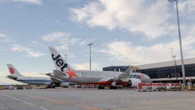 Jetstar and Air China passenger jets at an airport terminal.
